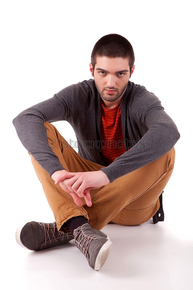 Similar – Young man sitting on the floor in urban background