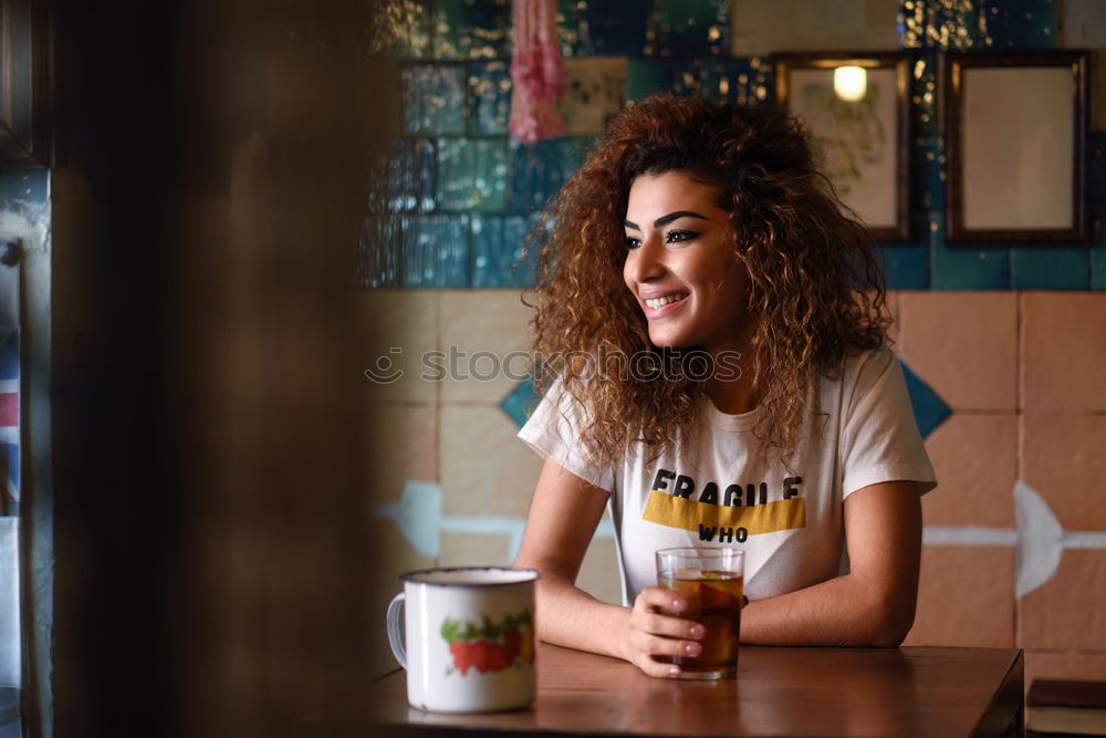 Young woman in casual clothes drinking a soda.