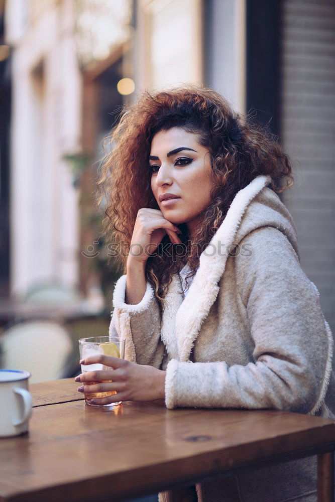 Similar – Young black woman drinking coffee wandering in the streets of Madrid on winter