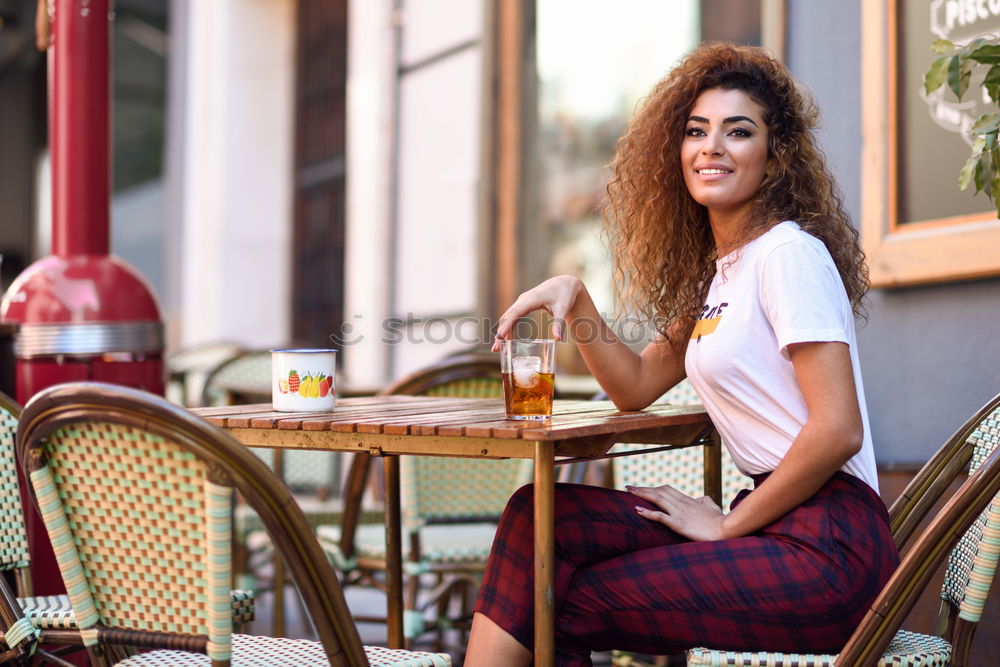 Image, Stock Photo Young woman smiling and sitting in an urban bar