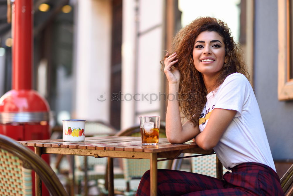 Similar – Image, Stock Photo Young woman smiling and sitting in an urban bar