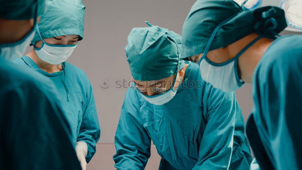 Similar – Image, Stock Photo Team of Surgeons Operating.