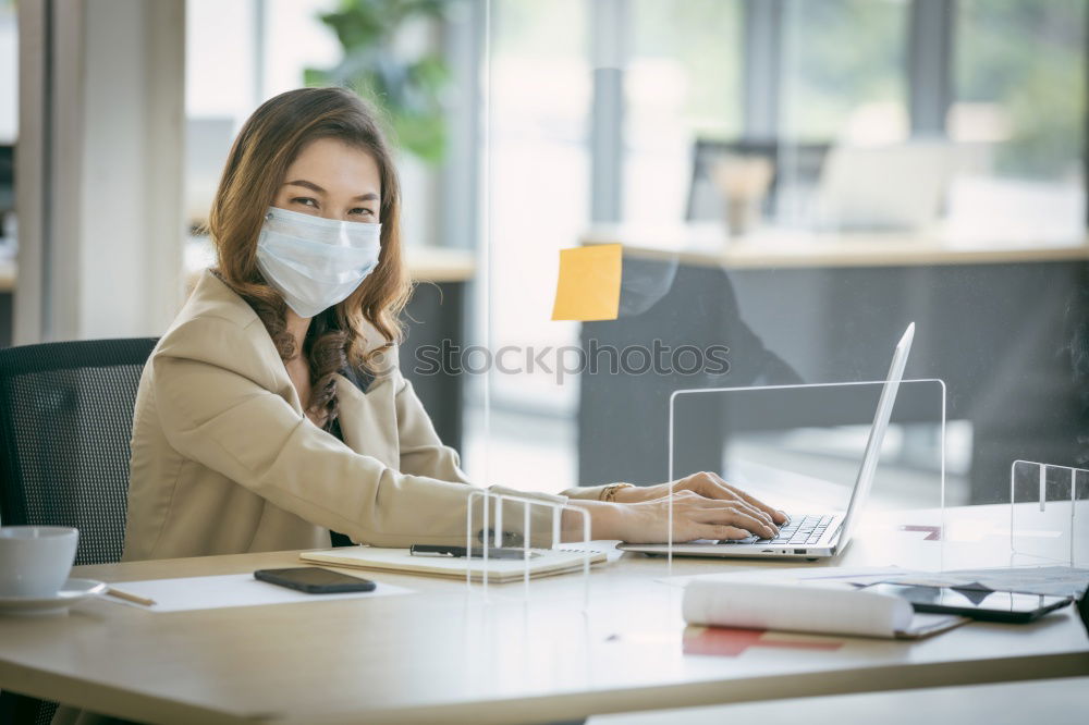 Similar – Young Businessman Wearing Mask Working On Laptop At Hot Desk In Office During Health Pandemic