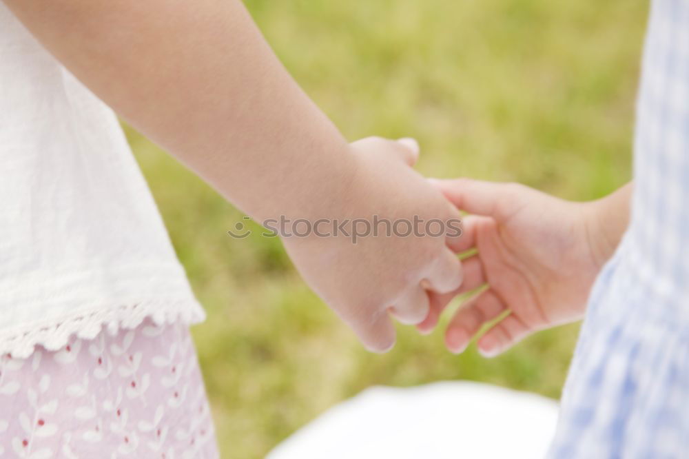 Two young women in walking holding her hands