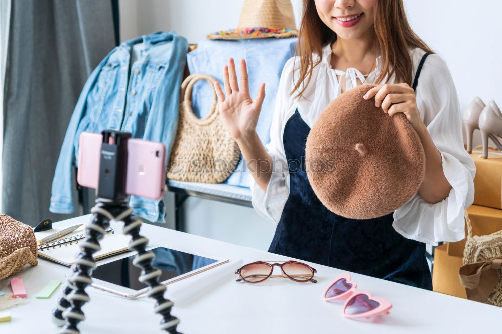 Similar – Young woman hanging clothes on coat hanger