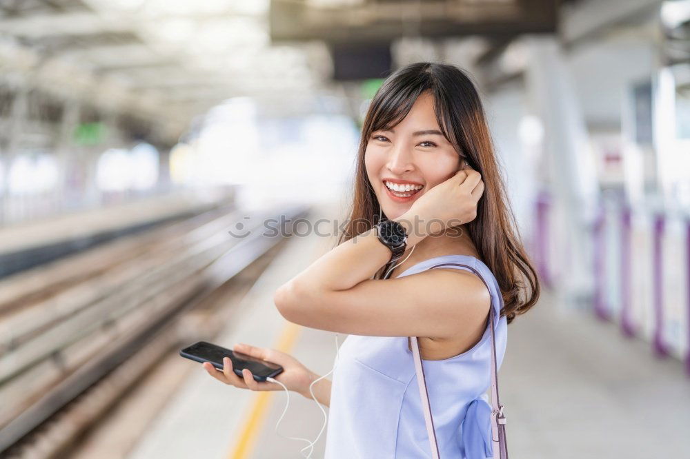 Similar – Fröhliches Mädchen steigt am Bahnhof mit Kaffee in der Hand in den Zug ein.