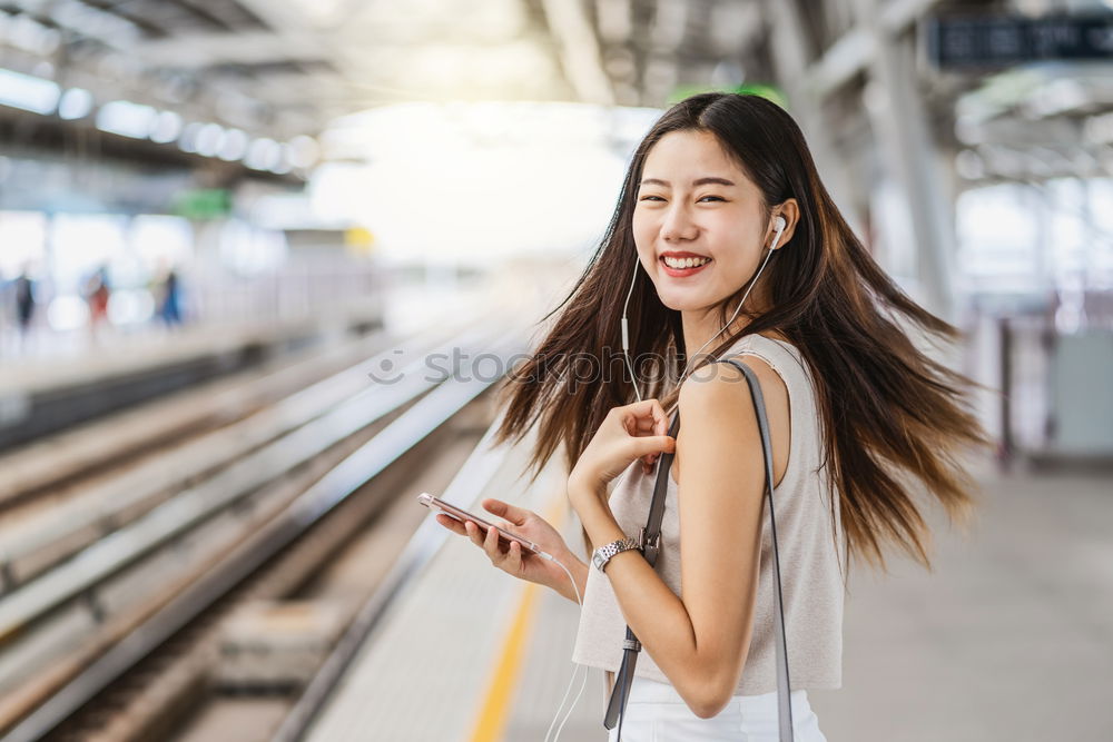 Similar – Fröhliches Mädchen steigt am Bahnhof mit Kaffee in der Hand in den Zug ein.