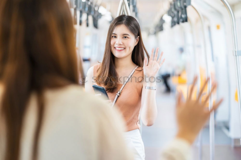 Similar – Fröhliches Mädchen steigt am Bahnhof mit Kaffee in der Hand in den Zug ein.