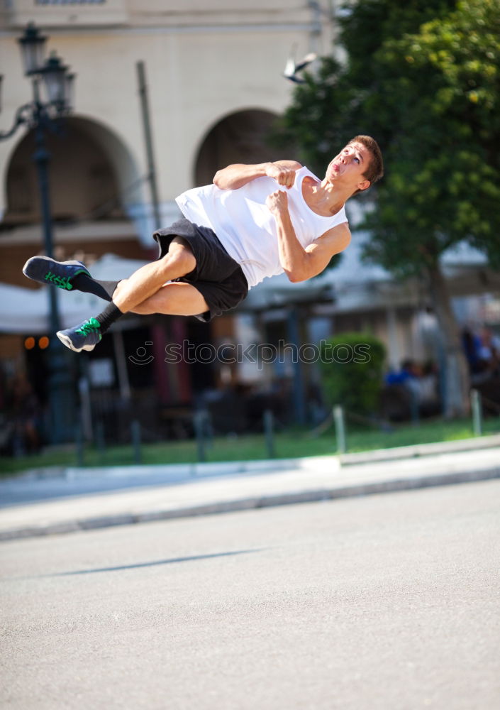 Similar – Motion shot of a young sportsman doing acrobatics in the city. Front flip trick