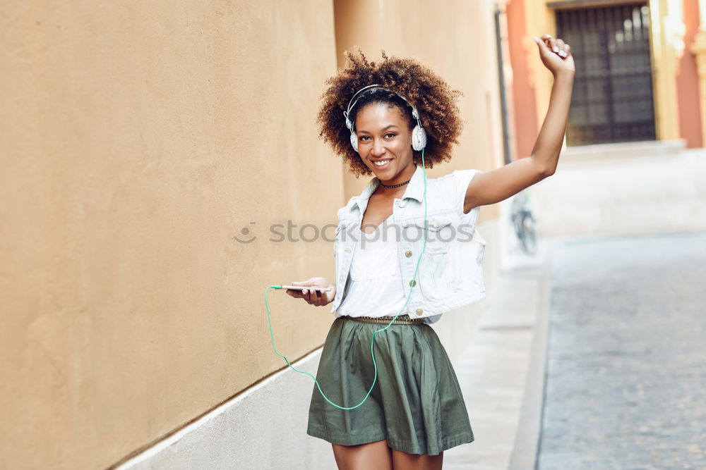 Young black woman, afro hairstyle, smiling outdoors