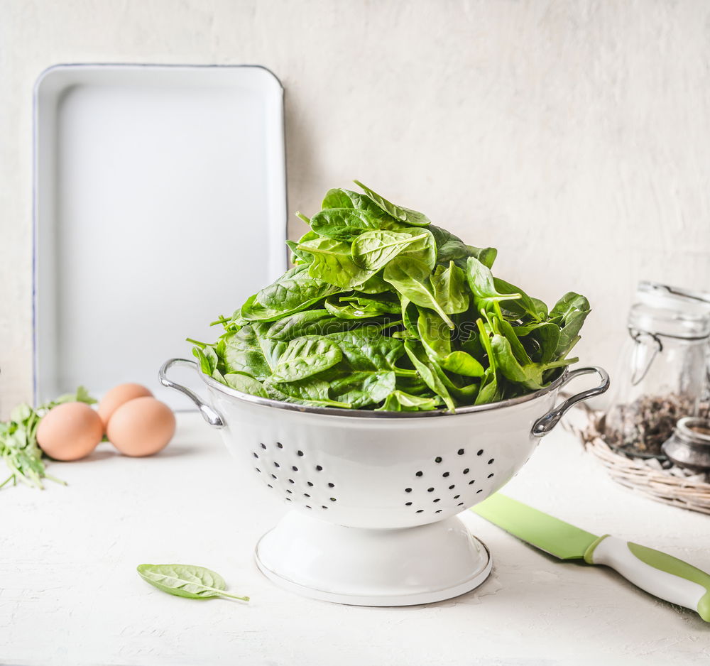 Empty plates and ingredients for spinach dishes