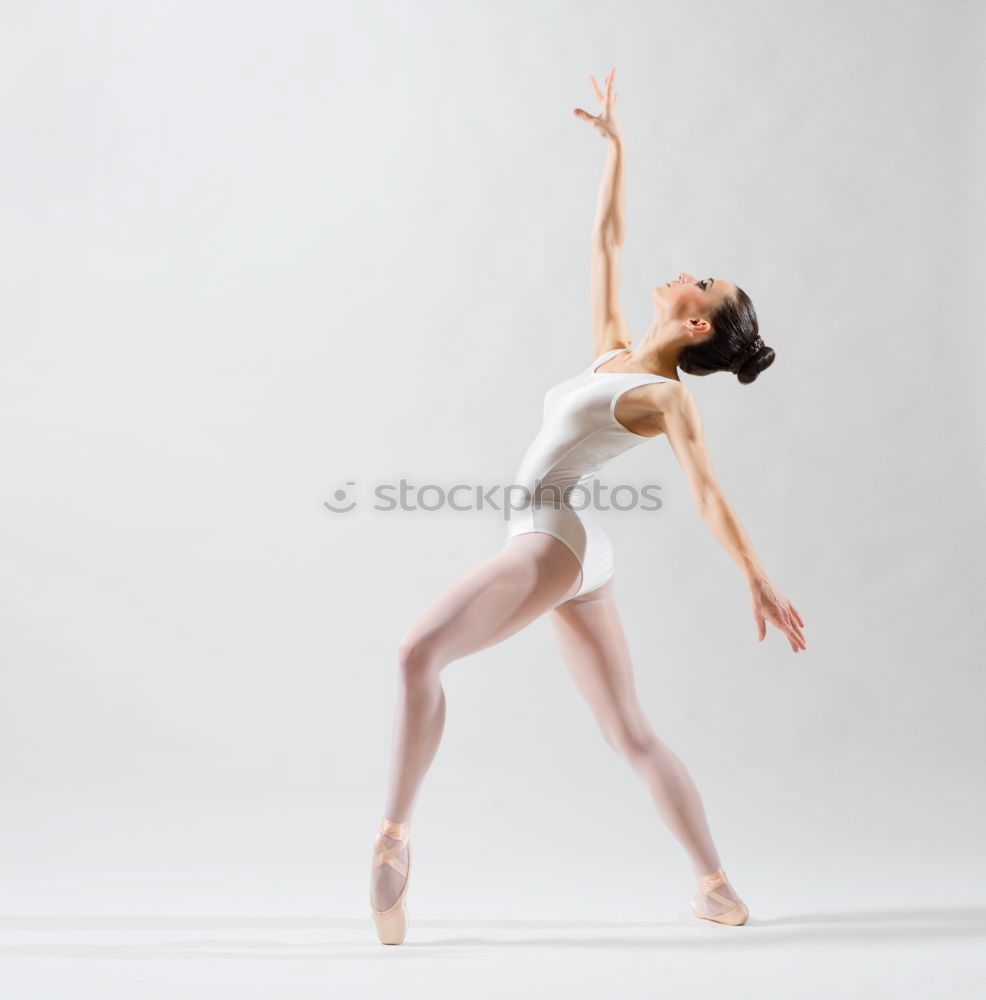 Similar – Top view at ballet dancer tying slippers around her ankle