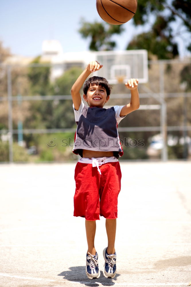 Similar – Teenage playing basketball on an outdoors court