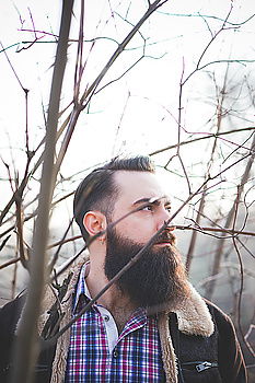 Similar – Bearded man in hat against sunlight