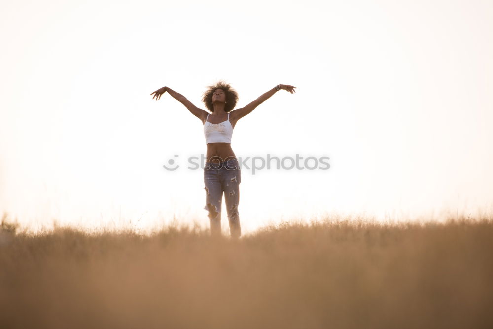 Similar – Young woman with her arms raised to the sky