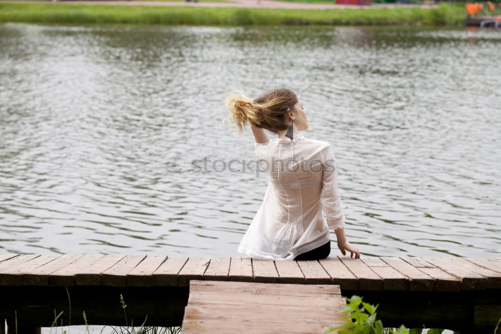 Similar – Image, Stock Photo Woman relaxing on a bridge in nature