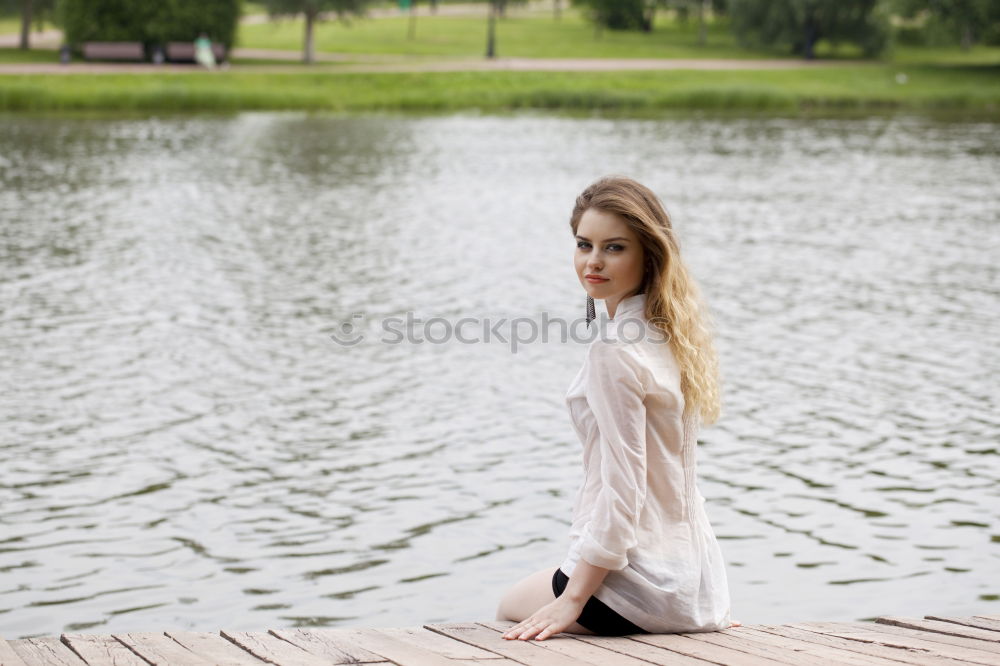 Similar – Woman with sunglasses plays with water