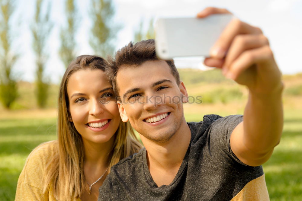 Similar – Image, Stock Photo Romantic Young Couple taking a photo with mobile phone.