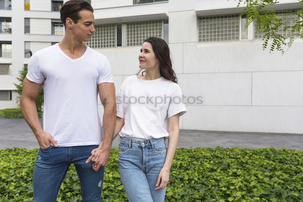 Similar – Side view Happy couple in love jumping against grey wall.