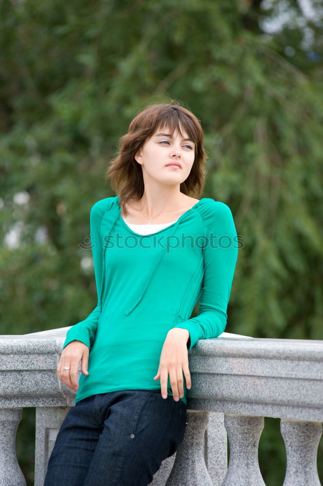 Similar – Redhead woman smelling a flower in a park