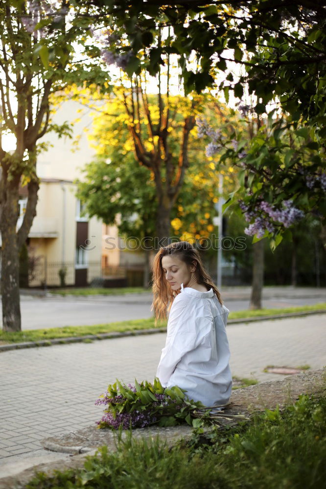 Similar – thoughtful woman with dreadlocks, in jeans and brown leather jacket is standing at an old dilapidated house wall