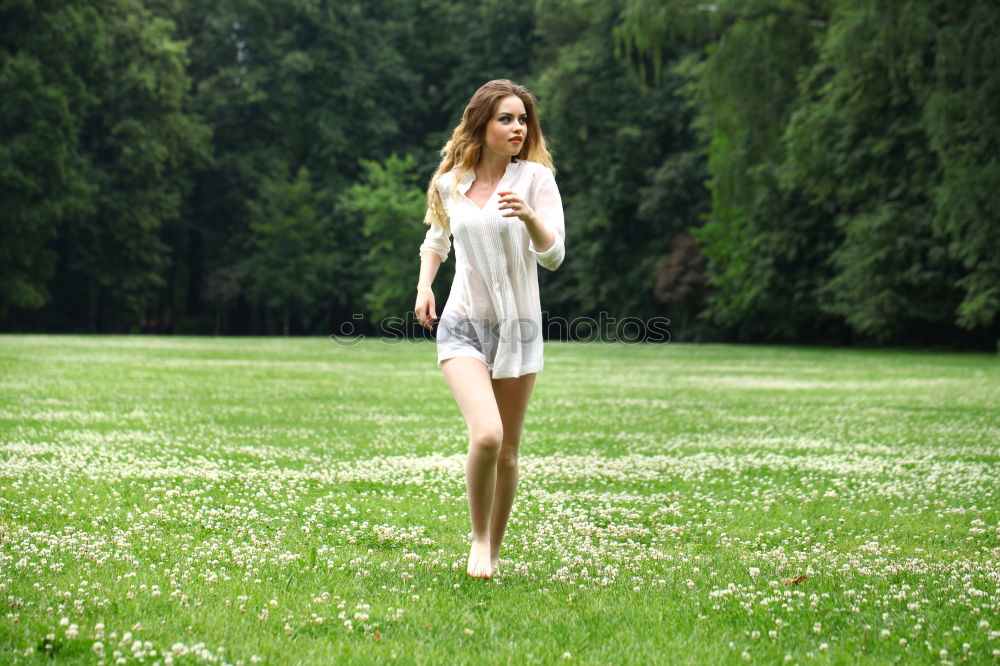 Similar – Image, Stock Photo Young, very athletic woman in skirt and t-shirt sits barefoot on a wooden bench in the forest with her legs crossed