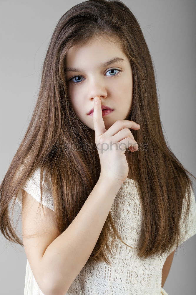 Similar – Young Girl Gesturing Silence.