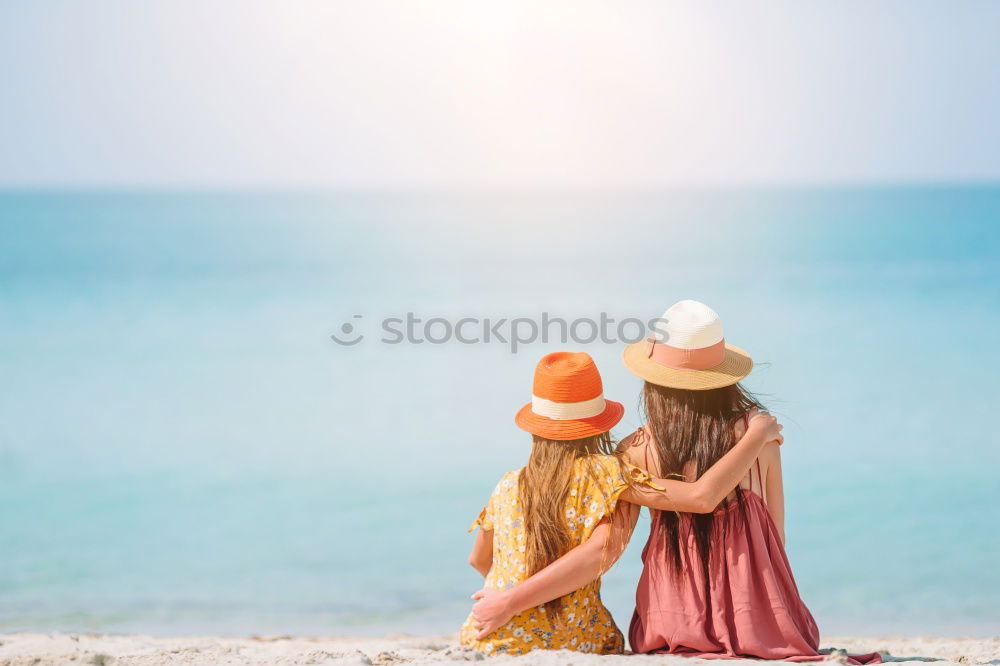 Similar – Mother and her daughter sitting on a bench on wintery day