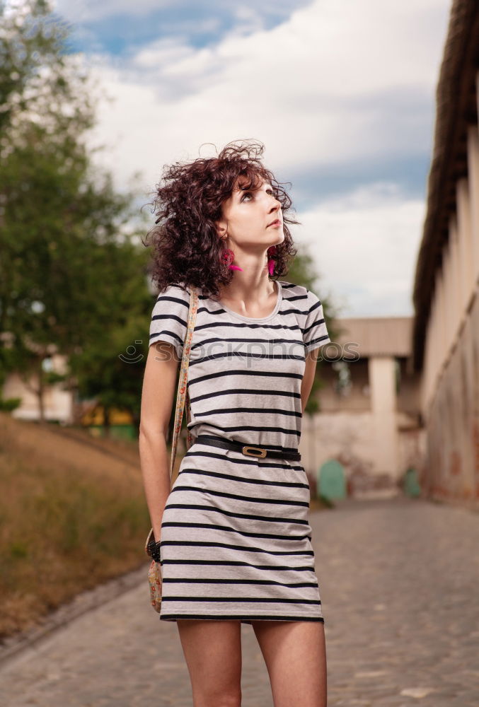 Similar – Young black woman with afro hairstyle smiling in urban park