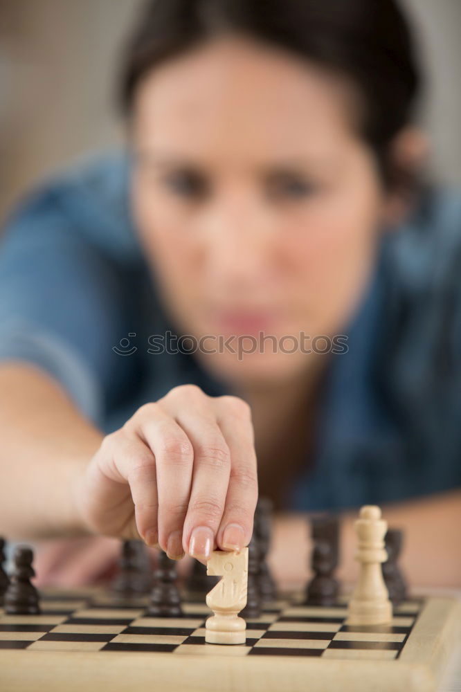 Similar – Girl and boy playing chess at home.