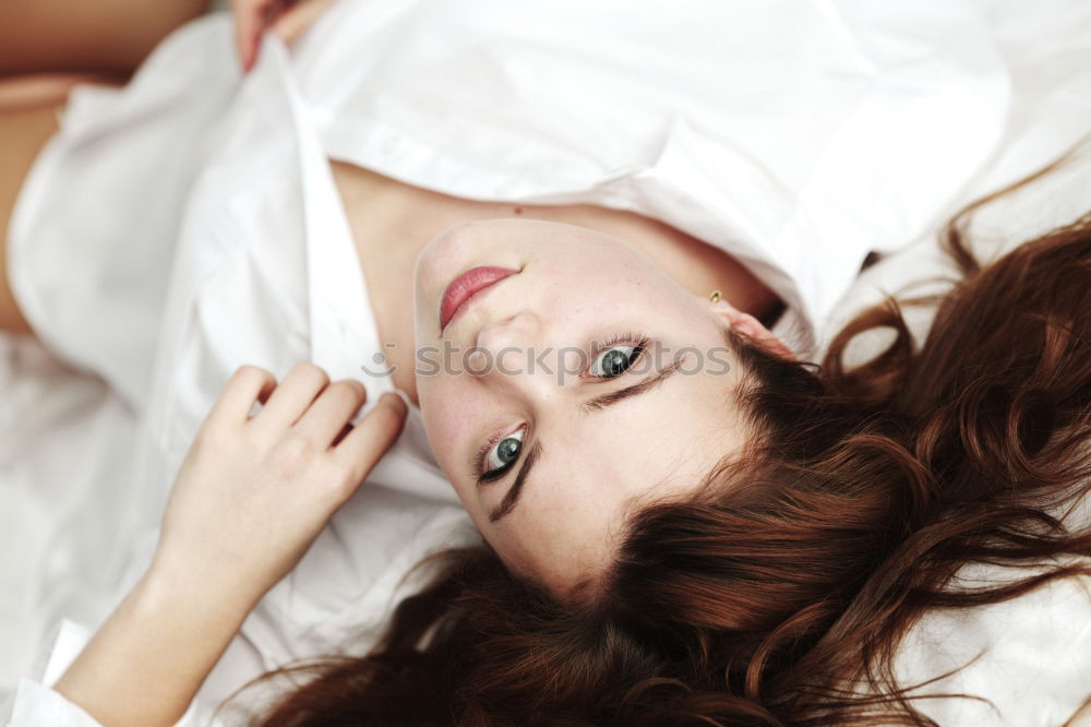 Similar – Smiling pretty woman on bed