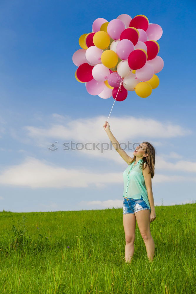 Similar – Young happy woman holding a heart shaped balloon