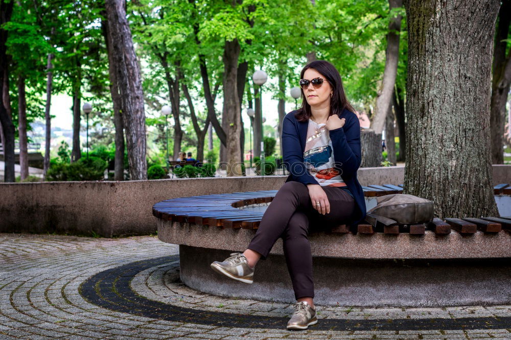 Similar – Woman enjoys sun on park bench