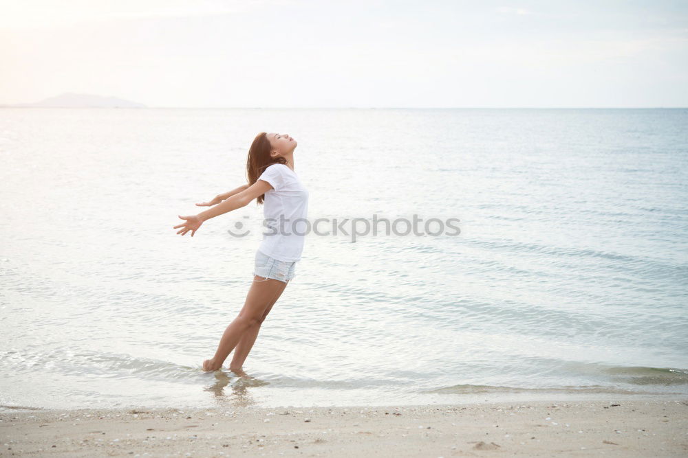 Similar – Asian woman standing on the terrace and looking around the sea.