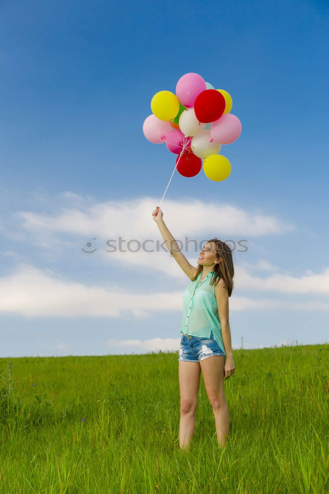 Similar – Young happy woman holding a heart shaped balloon