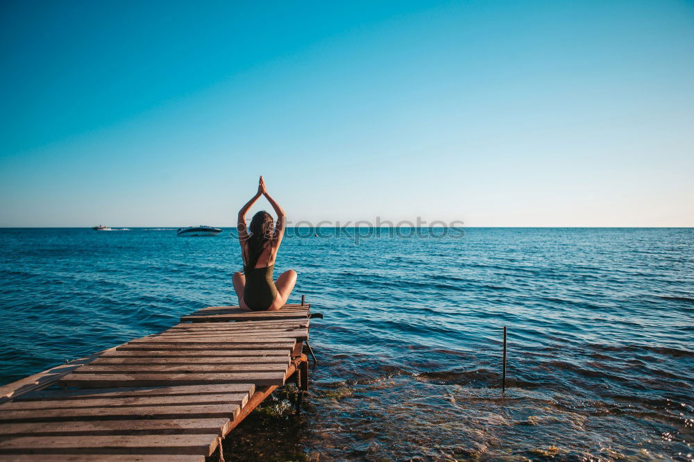 Anonymous female kicking air on seashore