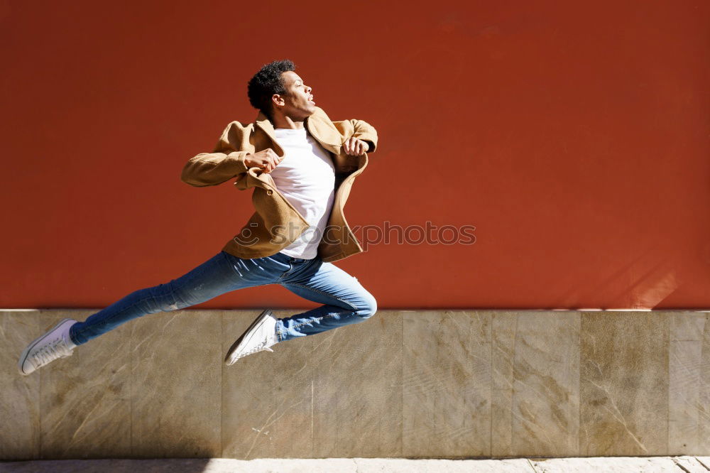 Similar – Image, Stock Photo Young black man wearing casual clothes jumping in urban background