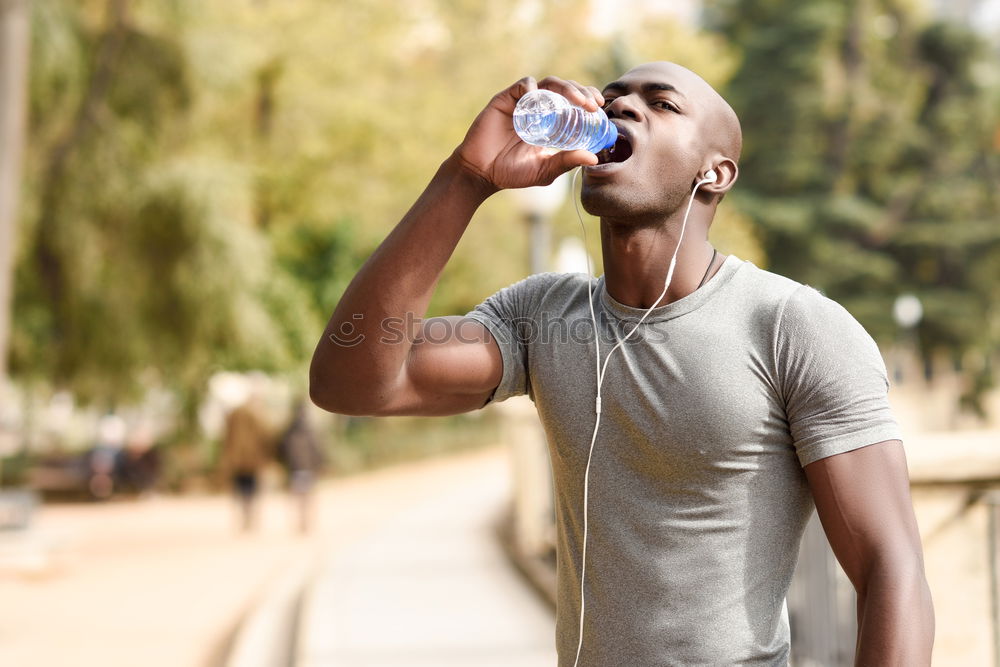 Similar – Young black man drinking water before running outdoors