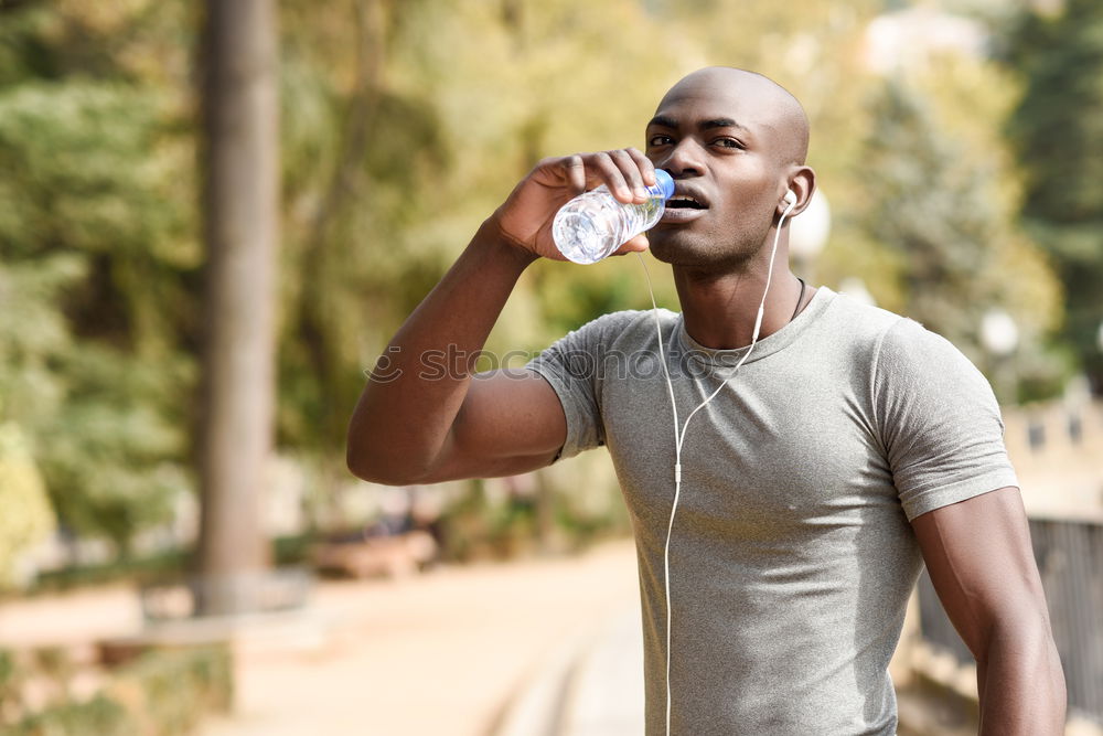 Similar – Young black man drinking water before running outdoors