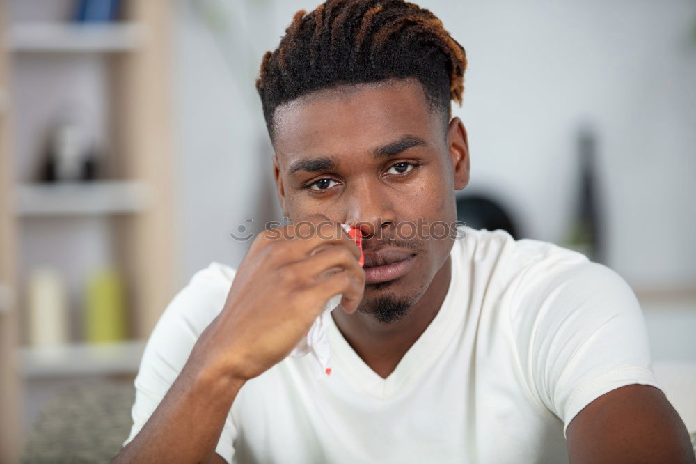 Similar – Portrait of a young thoughtful mixed race man sitting in the sofa