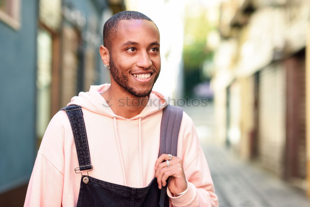 Similar – Young black man walking smiling down the street.