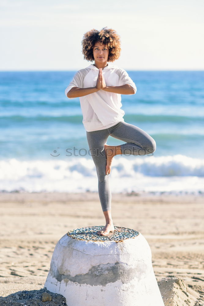 Similar – Black woman, afro hairstyle, doing yoga in the beach with eyes closed