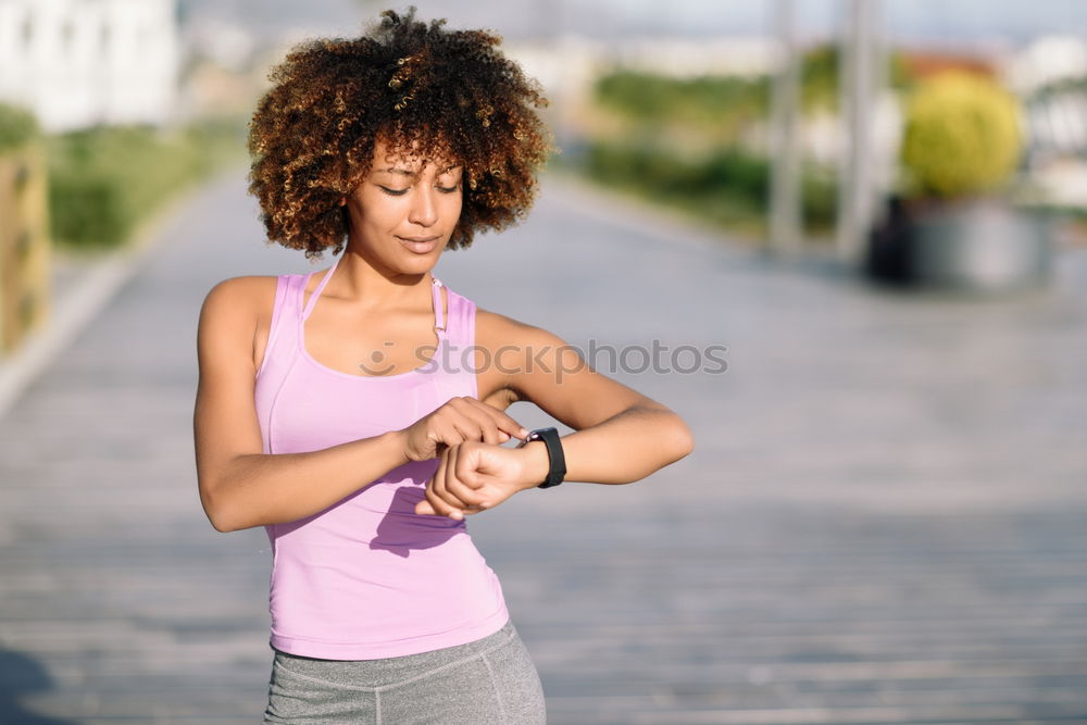 Black woman using smartwatch touching touchscreen