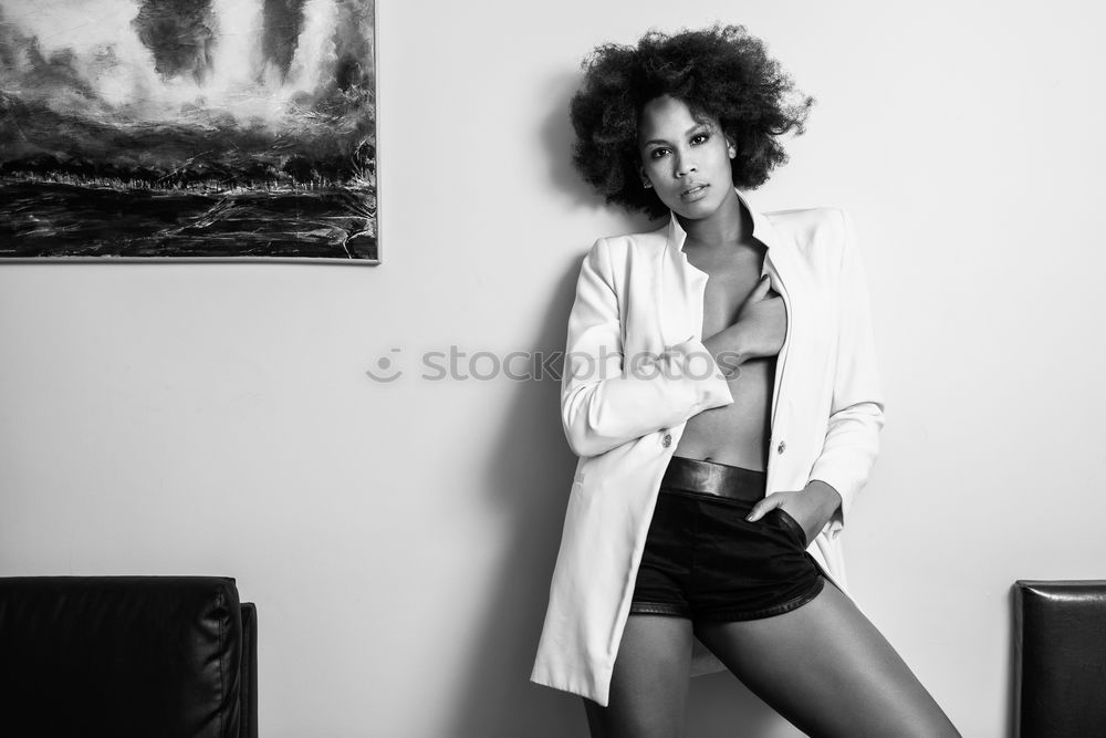 Similar – Happy young black woman sitting surrounded by flowers