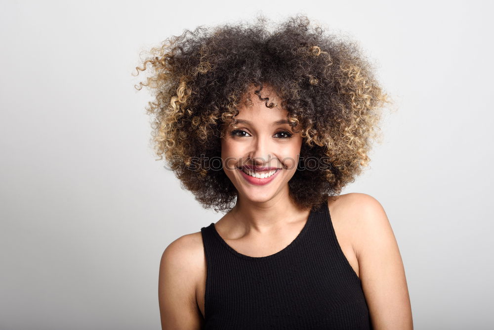 Similar – Young woman smiling with afro hairstyle and green eyes