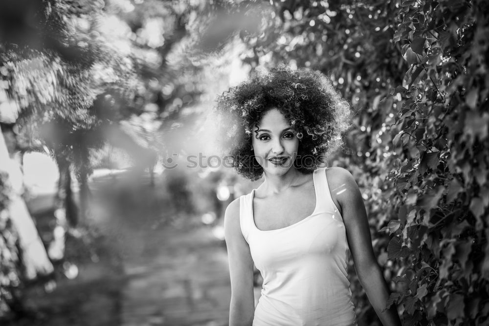 Beautiful young Arabic woman with black curly hairstyle