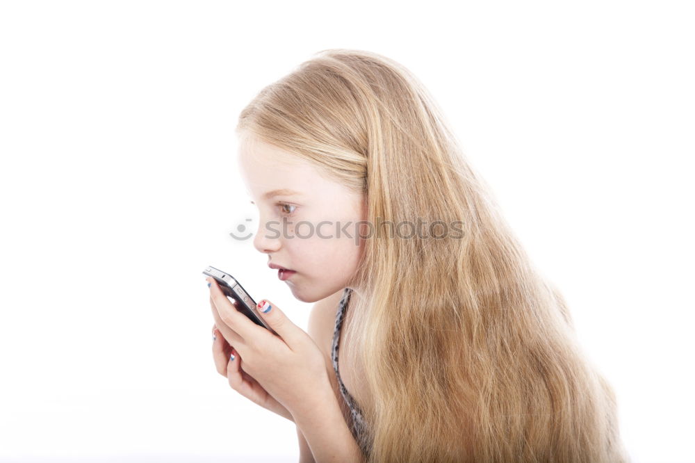 Similar – portrait of a beautiful kid using mobile phone