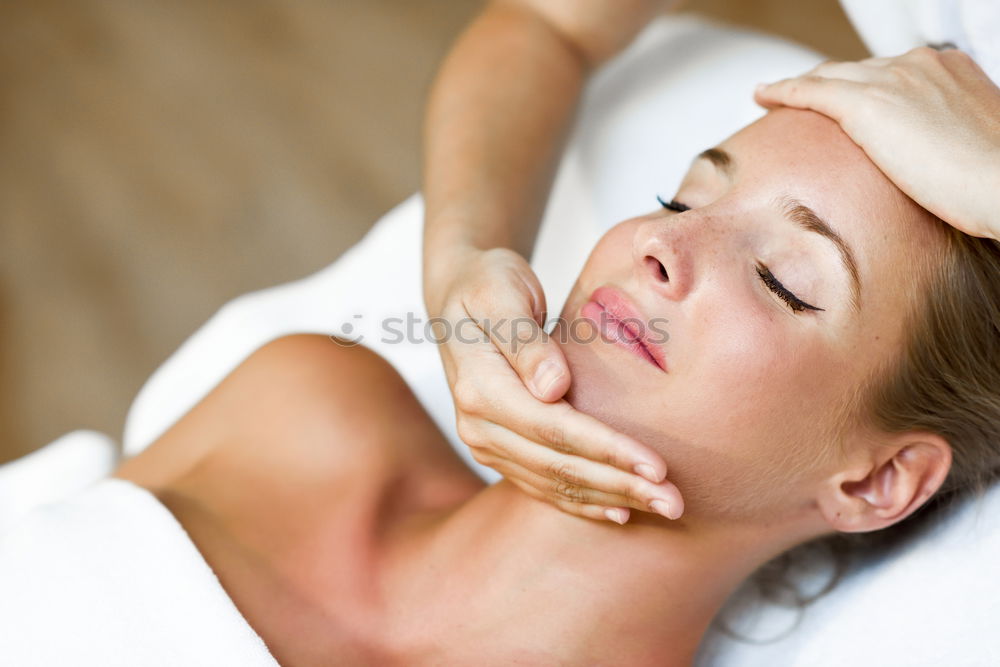 Similar – Young blond woman receiving a head massage in a spa center