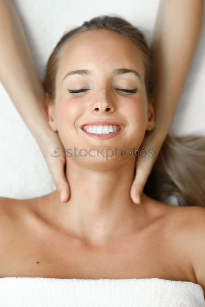 Similar – Young blond woman receiving a head massage in a spa center