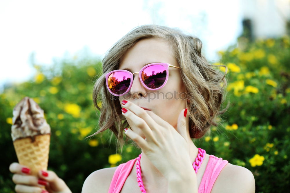 Similar – Young woman with pink hair is licking lollipops